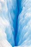 a glacier crevasse in blue color